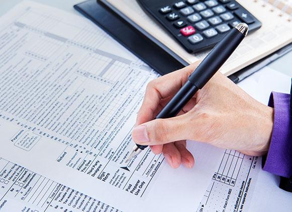 woman with paperwork doing some tax accounting in Norcross